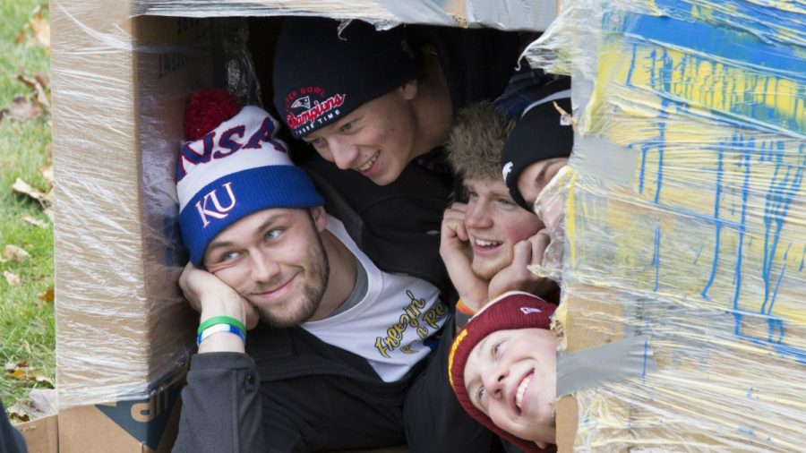 ATO members Cody Isabel, Reid Cobb, Trevor McKee and Michael Currie huddle inside a cardboard box to stay warm while raising money and awareness for the homeless for 24 hours. (Photo: Austin Hronich/The Simpsonian)