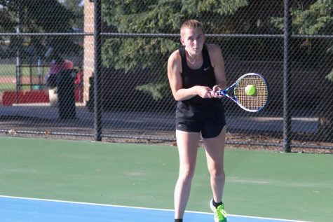 Junior Emily King slaps a backhand return in her No. 1 doubles match against Grand View University. She and Anna Wanek won the match 8-0.
