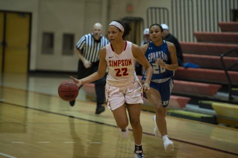 Nash streaks down the court past a University of Dubuque defender during the 2019-20 season.