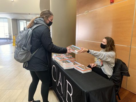Simpson student picks up a free puzzle from CAB’s weekly take & go. 