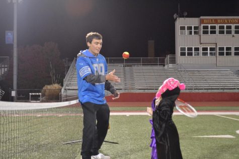 Caleb Vasconez plays tennis with kids who attended Trick or Treat with Athletes 
