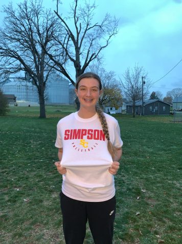 Finch posing with Simpson attire after committing to continue playing volleyball with The Storm 

