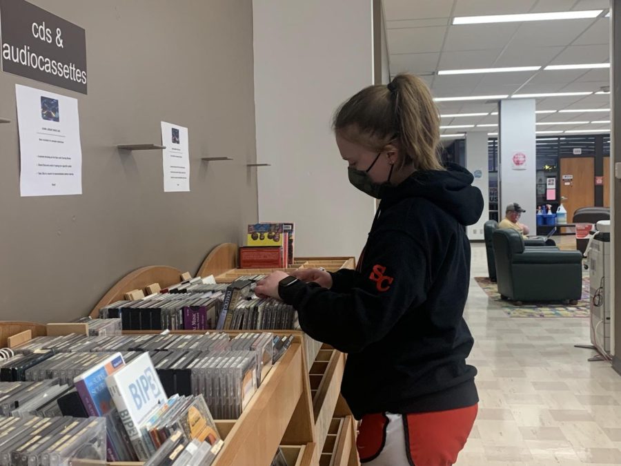 Bailey Petersen going through the CDs in Dunn Library