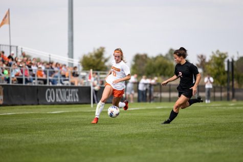 Forward Senior Katie Berglund (#21) takes on Storm defender #2 Brooklin Froehlich in the Fall 2022 matchup in Waverly, IA at Wartburg College.

