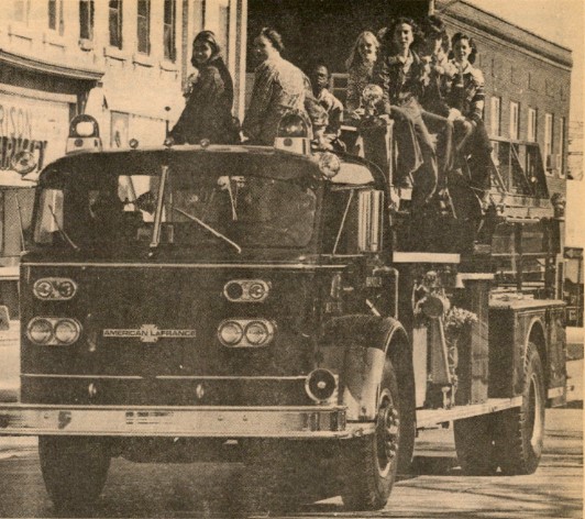 1975s Homecoming court of 16 people, one from each housing unit, on their way to great wall