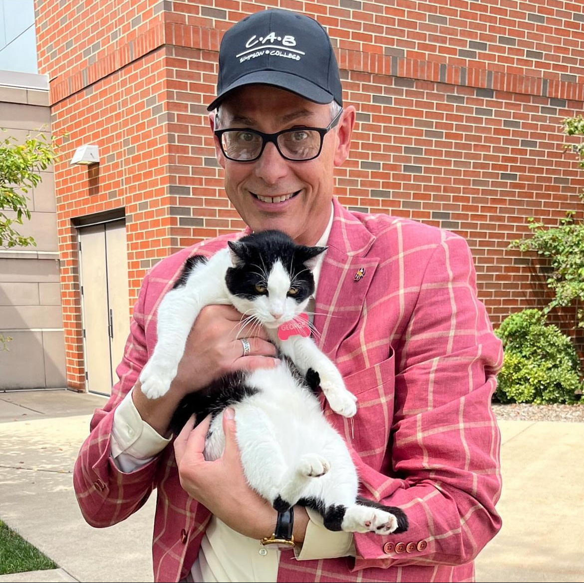 Simpson College President Jay Byers holding George the campus cat outside of Kent Campus Center. (Submitted from Jay Byers' Instagram)