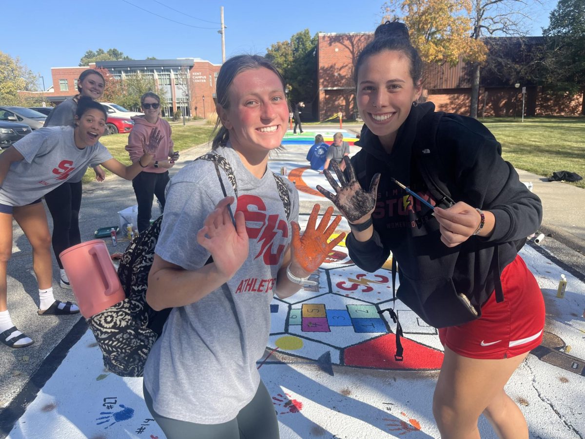 Women's Soccer works on their street painting 