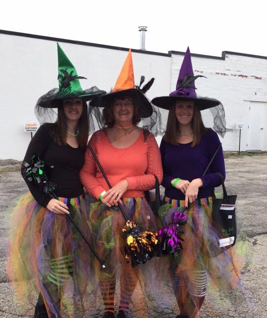 Attendees of Wine, Witches, and Brews show off their costumes