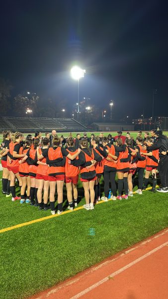 The Simpson women’s soccer huddle before embarking on the 2024 D III women’s soccer tournament.