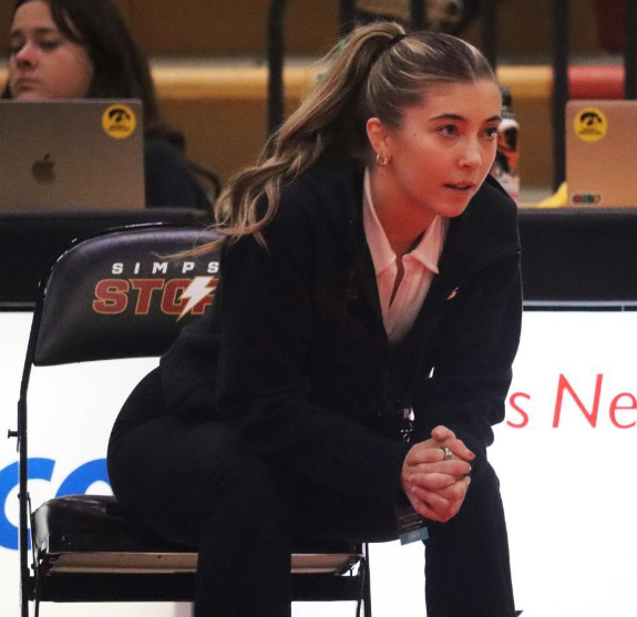 Simpson College Women’s Wrestling assistant coach Emma Cochran coaching on the sidelines at the NCWWC Regional Championship last season