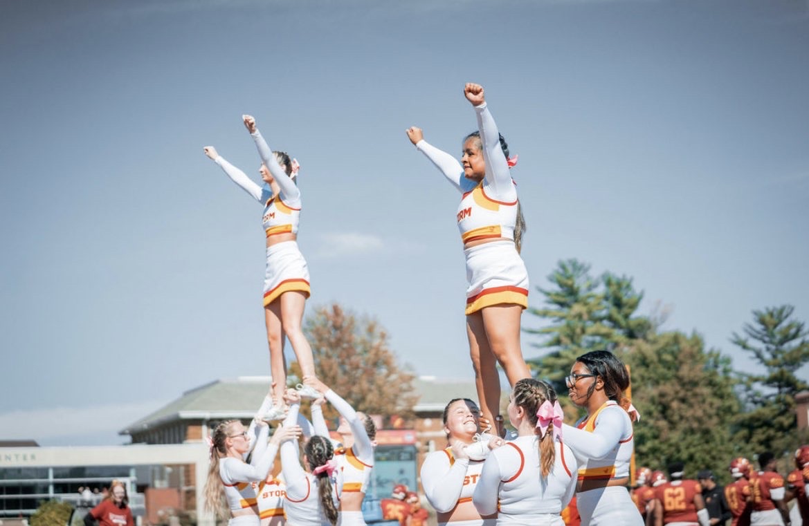 The Simpson College cheer team is making two pyramids