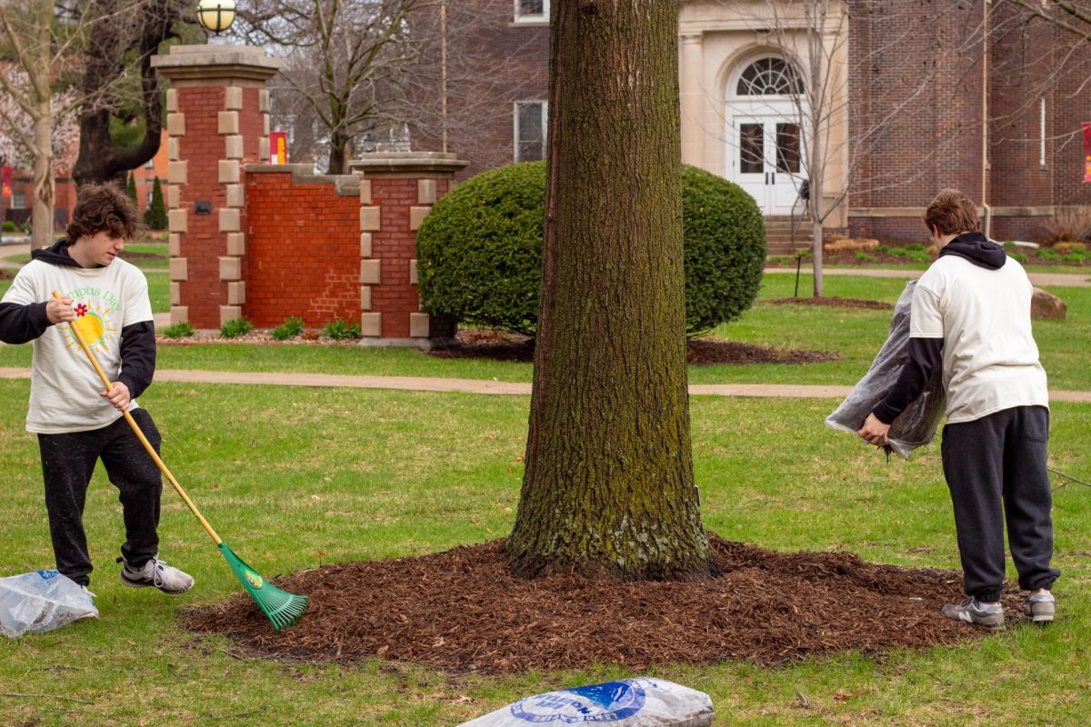 Simpson students Ethan Drake and Cody Midboe adding mulch on campus for Campus Day 2025