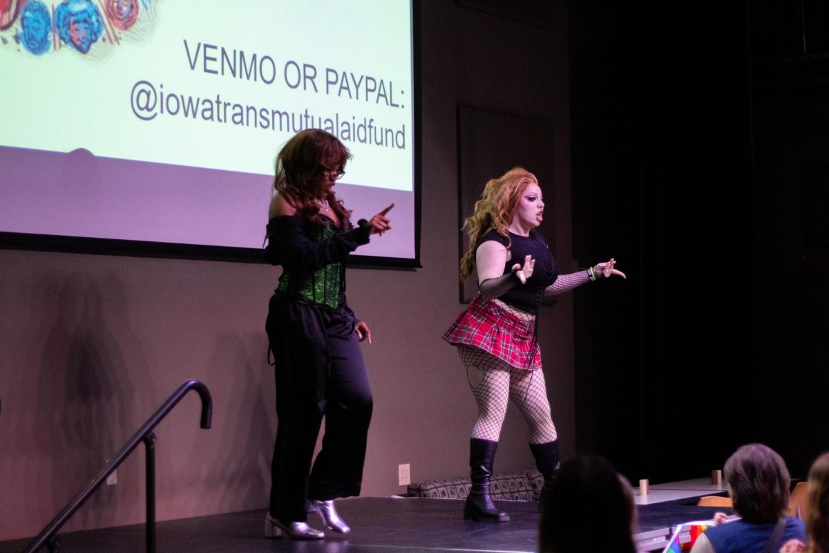 Drag show winners Leigh D. Parts and Genesis Row performing on stage in Black Box
